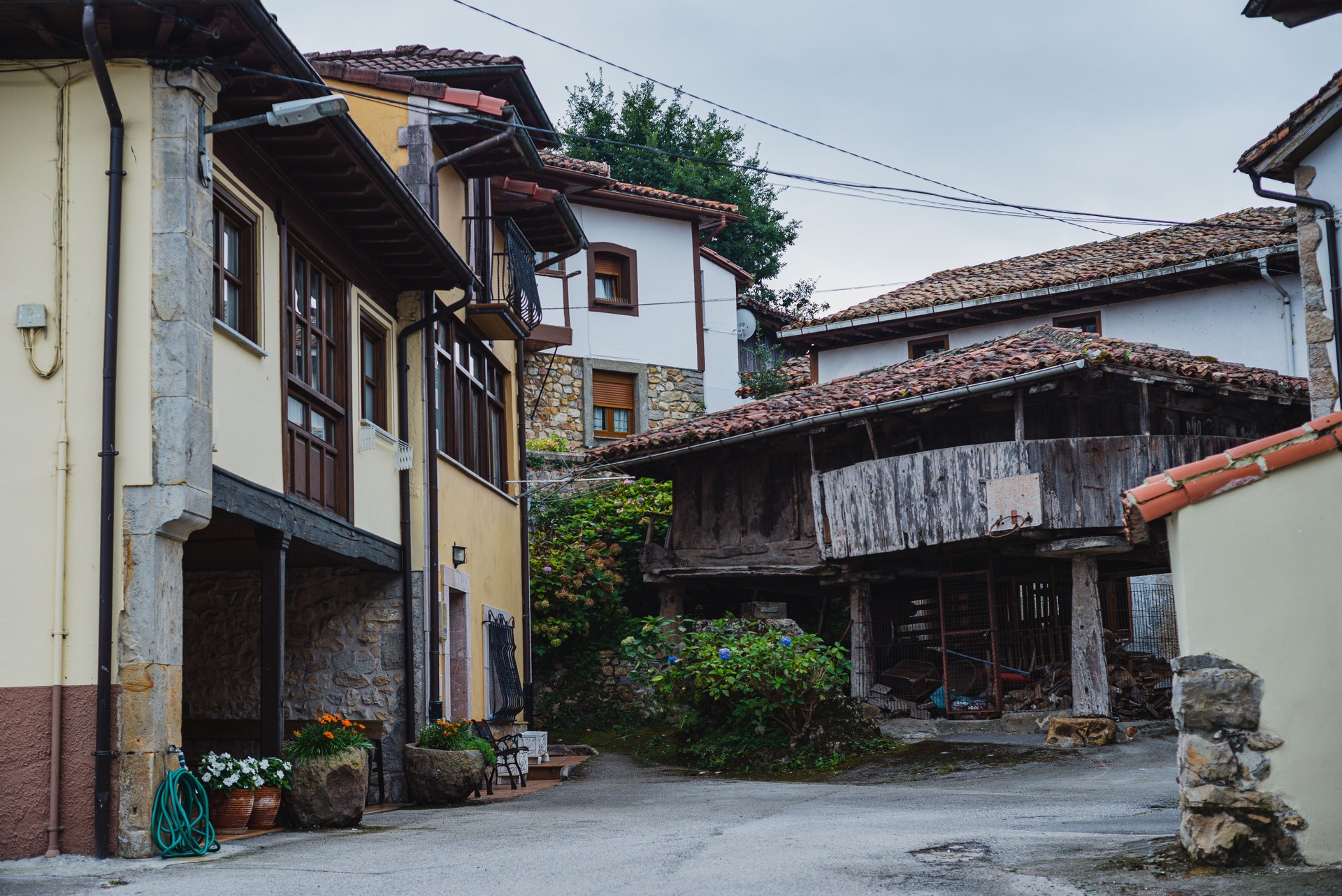 typical street of the asturian villages (spain) with stone houses and dark roofs.